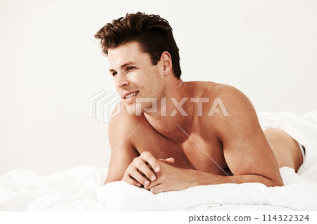 Happy, relax and young man with muscles on a bed with positive, good and confident attitude. Smile, strong and male person or bodybuilder laying in bedroom after workout or exercise in apartment. Happy, relax and young man with muscles on a bed with positive, good and confident attitude. Smile, strong and male person or bodybuilder laying in bedroom after workout or exercise in apartment. 114322324