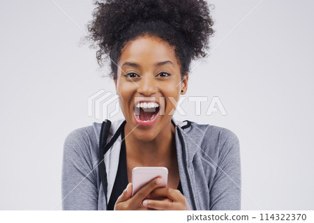 You should see this. Studio shot of a young woman looking surprised while reading something on her cellphone. You should see this. Studio shot of a young woman looking surprised while reading something on her cellphone. 114322370