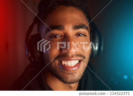 Portrait, man and esports competition for gaming online video games and virtual challenge at night. Gamer, nerd and dark room with technology for live streaming cyber contest on computer in home 114322371