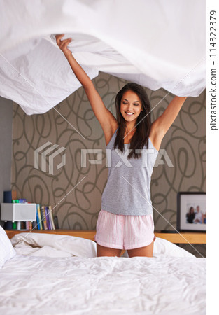 Woman, bedroom and sheet for morning cleaning in apartment in pajamas on weekend, organized or bedding. Female person, linen and house or tidy housework or change fabric or duvet, domestic or blanket Woman, bedroom and sheet for morning cleaning in apartment in pajamas on weekend, organized or bedding. Female person, linen and house or tidy housework or change fabric or duvet, domestic or blanket 114322379