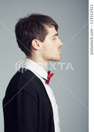 Profile, business and fashion with man, thinking and confident guy on grey studio background. Person, entrepreneur or model with stylish outfit, elegant clothes or worker with professional or bow tie 114322421