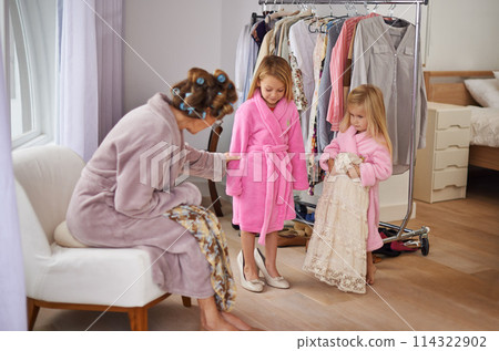 Fashion, clothes and mother with children in wardrobe for dressing, beauty and choose outfit. Family, happy and mom and young girls with clothing, style and makeover for bonding, fun and cosmetics Fashion, clothes and mother with children in wardrobe for dressing, beauty and choose outfit. Family, happy and mom and young girls with clothing, style and makeover for bonding, fun and cosmetics 114322902