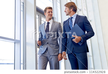 Businessmen, smile and walking in office building with paperwork or project, meeting or corporate. Male people, colleagues and documents in hallway in London law firm, professional or collaboration Businessmen, smile and walking in office building with paperwork or project, meeting or corporate. Male people, colleagues and documents in hallway in London law firm, professional or collaboration 114322928