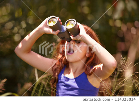 Little girl, binoculars and nature for sightseeing, explore or outdoor vision in the woods. Young female person, child or teenager enjoying sight, adventure or bird watching and search in forest Little girl, binoculars and nature for sightseeing, explore or outdoor vision in the woods. Young female person, child or teenager enjoying sight, adventure or bird watching and search in forest 114323034