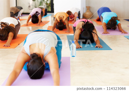 Childs pose, yoga and people with personal trainer for class stretching, exercise and workout on mat. Pilates, club and instructor with men and women for wellness, balance and flexible for health Childs pose, yoga and people with personal trainer for class stretching, exercise and workout on mat. Pilates, club and instructor with men and women for wellness, balance and flexible for health 114323066