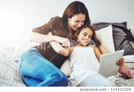 Smile, mother and kid on tablet in bed at home together for game, bonding and family streaming movie. Happy girl, mom and technology in bedroom for learning, education or reading ebook on app online Smile, mother and kid on tablet in bed at home together for game, bonding and family streaming movie. Happy girl, mom and technology in bedroom for learning, education or reading ebook on app online 114323109