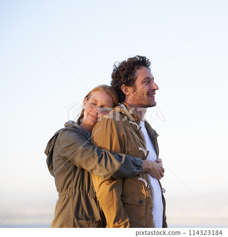 Couple, hug outdoor and peace in park, love and support with date for bonding and time together. Sunset, nature and people with calm and fresh air, loyalty and commitment with smile for affection 114323184