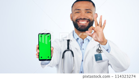 Phone, okay sign and portrait of doctor with green screen agreement or registration in white background. Studio, healthcare or hand for ok, yes and mobile app success for telehealth services mockup 114323274