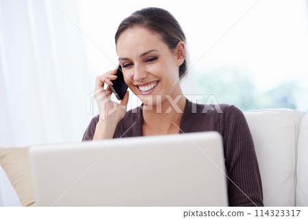 Happy, woman and phone call with laptop on couch for remote work in communication or social media. Virtual, contact and person in home with networking on computer online and talking on smartphone 114323317