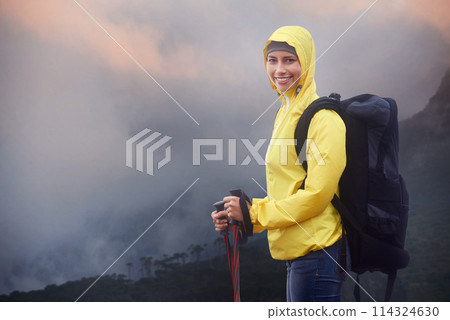 Woman, hiking and portrait with trekking sticks, winter and support for fog trail in mountain. Athlete, backpack and happy face with gear for safety, clouds and walking for fitness wet environment Woman, hiking and portrait with trekking sticks, winter and support for fog trail in mountain. Athlete, backpack and happy face with gear for safety, clouds and walking for fitness wet environment 114324630