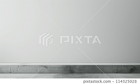 An empty room with a grey wall, hardwood flooring, and a concrete rectangle 114325028
