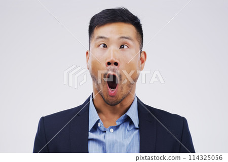 Businessman, crazy and wow face in studio for emoji, comedy and fun by white background. Asian male person, emotions and silly for joke, prank and comic for humour and laugh isolated on backdrop Businessman, crazy and wow face in studio for emoji, comedy and fun by white background. Asian male person, emotions and silly for joke, prank and comic for humour and laugh isolated on backdrop 114325056