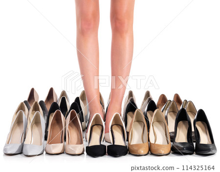 Customer, legs and shopping for shoes, fashion and luxury in studio. Woman, standing and high heels for style, designer and retail sale on isolated white background with mockup in store with choice 114325164