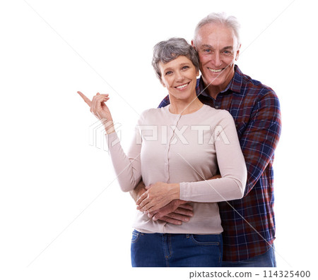Happy, pointing and senior couple in studio, hug together or customer loving relationship for retired people. Information, advertising or presentation on background, promotion show on mockup space 114325400