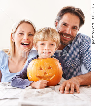 Portrait, parents and kid with pumpkin for halloween to celebrate with fun together. Happy family, mom and dad with boy child carving face in vegetable for holiday lantern, decoration and party Portrait, parents and kid with pumpkin for halloween to celebrate with fun together. Happy family, mom and dad with boy child carving face in vegetable for holiday lantern, decoration and party 114325412