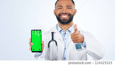 Phone, green screen and portrait of doctor with thumbs up, agreement or registration in white background. Studio, healthcare or sign for like, yes and ok mobile app for telehealth services or success 114325525
