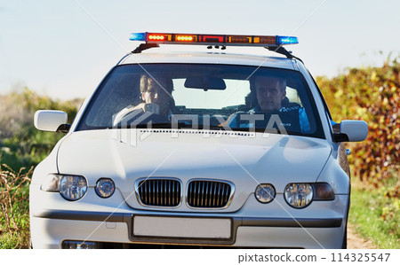 Policeman, car and drive in field to search at crime scene or robbery, safety and law enforcement for evidence. Detective, investigation and uniform in outdoor working at countryside with gravel road 114325547
