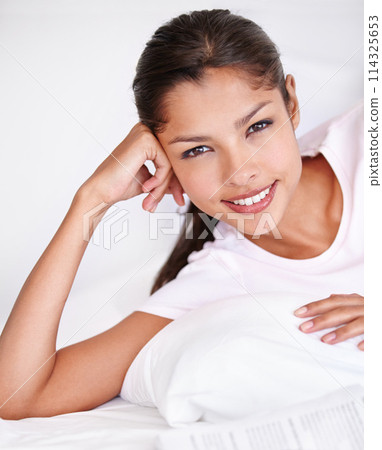 Woman, happy and portrait in bed on vacation, lazy and comfortable on morning at home. Female person, peaceful and satisfaction while resting in bedroom, wake up and good mood on holiday or getaway 114325653