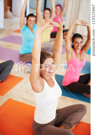 Portrait, stretching and smile, woman in yoga class with happiness, commitment and body wellness. Mindfulness, exercise and women in holistic club together with people, balance and fitness in pilates 114325667