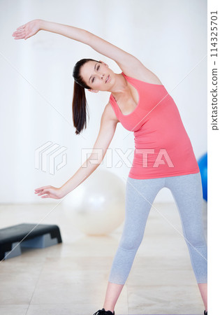 Stretching arms, portrait or woman in gym with fitness for body flexibility, health or wellness. Relax, athlete or sports person ready for workout, training or exercise warm up for mobility in USA Stretching arms, portrait or woman in gym with fitness for body flexibility, health or wellness. Relax, athlete or sports person ready for workout, training or exercise warm up for mobility in USA 114325701