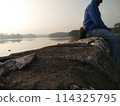 A man who is enjoying the natural scenery with an eye on the future 114325795