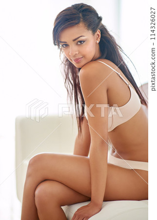 Shes the woman of your dreams. a gorgeous young woman posing seductively in her bedroom. 114326027