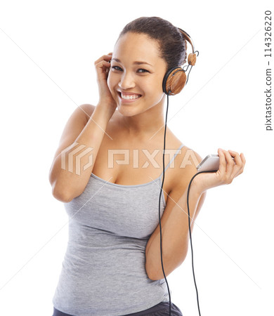 Happy woman, portrait and headphones listening to podcast for audio streaming against a white studio background. Female person smile enjoying sound track, music or playlist on smartphone with headset Happy woman, portrait and headphones listening to podcast for audio streaming against a white studio background. Female person smile enjoying sound track, music or playlist on smartphone with headset 114326220