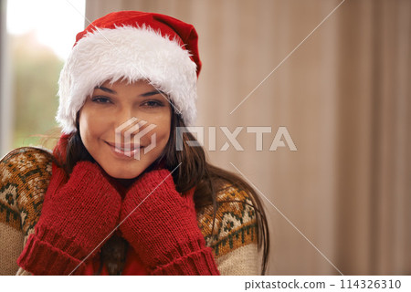 Portrait, smile and Santa hat for Christmas with woman in home for December, festive or holiday celebration. Face, fashion and winter with happy young person in apartment for vacation season 114326310