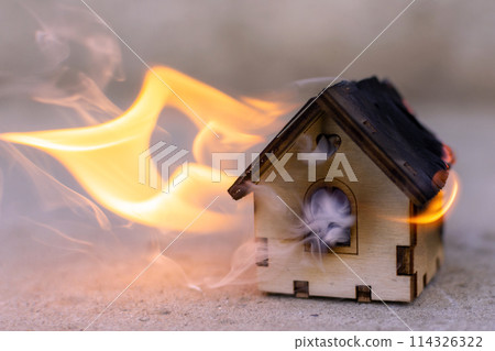 toy wooden house is on fire. fire, disaster toy wooden house is on fire. fire, disaster 114326322