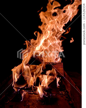 flames when burning firewood on a black background flames when burning firewood on a black background 114326334