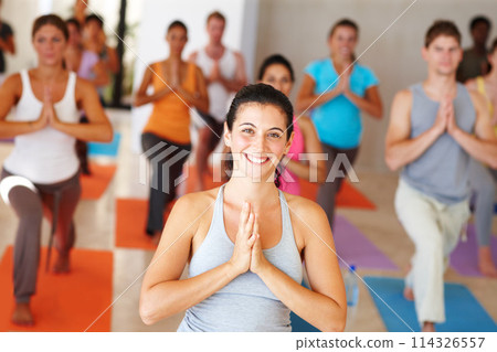 Portrait, class and yoga group with an instructor in a studio for health, wellness or holistic training. Exercise, smile or meditation with a yogi teaching students about zen, balance or inner peace 114326557