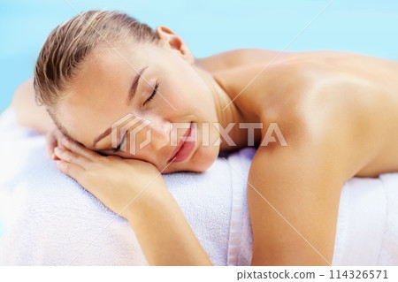 Woman, sleeping and health on bed in spa to relax, wellness and recovery with rest, peace and quiet. Girl, calm and natural at resort for rehabilitation, blue sky or physical therapy for body fatigue 114326571
