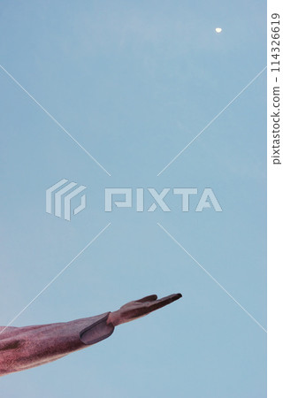 Jesus christ, hand and statue for religious faith, sculpture and art in rio de janeiro. Symbol, peace and history monument for tourism attraction, spiritual and christian journey on blue background 114326619