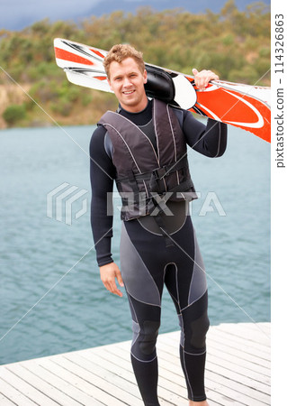 Water ski, portrait and man by lake with wakeboard for surfing, exercise and recreation hobby outdoors. Fitness, extreme sports and excited person with board for skiing for freedom, adventure and fun Water ski, portrait and man by lake with wakeboard for surfing, exercise and recreation hobby outdoors. Fitness, extreme sports and excited person with board for skiing for freedom, adventure and fun 114326863