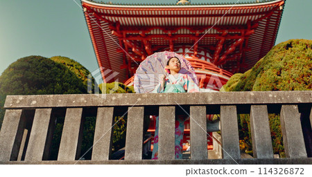 Japanese woman, umbrella and shinto temple with traditional clothes, culture and religion in sunshine. Person, girl and parasol for walk with faith, mindfulness and thinking with low angle in Kyoto Japanese woman, umbrella and shinto temple with traditional clothes, culture and religion in sunshine. Person, girl and parasol for walk with faith, mindfulness and thinking with low angle in Kyoto 114326872
