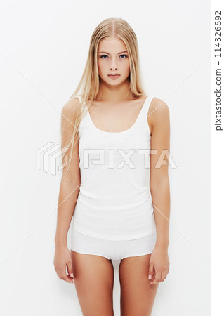 Skincare, portrait and young woman in underwear, white background for beauty, grooming or wellness. Clean, health or female model in clothes, dermatology body glow and studio backdrop with mockup 114326892