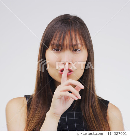 Model, portrait and gesture with secret, studio and silence for mystery announcement. Woman, gossip and hush with rumor, whisper and finger on lips for news or noise with privacy on white background 114327001
