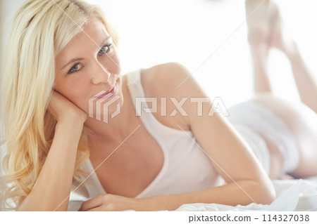 Relax, carefree and portrait of girl on bed with smile, morning health or wellness on weekend in home. Wake up, underwear and happy woman in bedroom for rest, comfort or fresh start to day in Norway 114327038