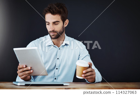 Tablet, business man and drinking coffee or research in studio isolated on a black background mockup. Serious, tea and professional on tech online or agent reading email on web app for news at desk Tablet, business man and drinking coffee or research in studio isolated on a black background mockup. Serious, tea and professional on tech online or agent reading email on web app for news at desk 114327063