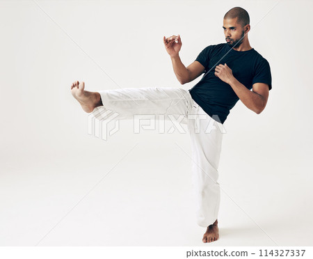 Man, studio and karate for kick practice, action and martial arts on white background. Black male person, mockup space and training for combat, fight and position of attack in taekwondo for fitness 114327337