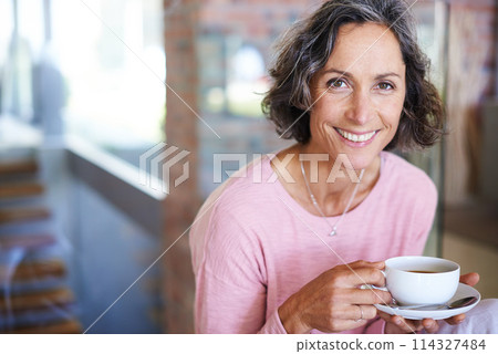 Mature woman, home and smile with coffee to relax on day off and leisure. Female person, holiday and happy in living room with cup of tea for lunch on break, chill and self care in portrait. 114327484