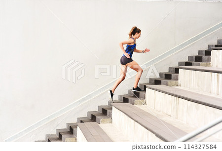 Female athlete, stairs and cardio for sports, exercise and fit on steps for endurance, physical and activity. Healthy, woman and training in running, wellness and muscles for strong, body and mind Female athlete, stairs and cardio for sports, exercise and fit on steps for endurance, physical and activity. Healthy, woman and training in running, wellness and muscles for strong, body and mind 114327584