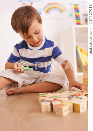Boy, child and building blocks for toys, playing and learning with development and growth at home in playroom. Fun, activity and playful with wood bricks, young toddler kid and educational games 114327618