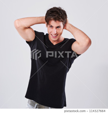 Attractive man, fashion and style with hair, tshirt or grooming on a gray studio background. Handsome male person, caucasian or young model with trendy hairstyle, casual clothing or barber treatment Attractive man, fashion and style with hair, tshirt or grooming on a gray studio background. Handsome male person, caucasian or young model with trendy hairstyle, casual clothing or barber treatment 114327664