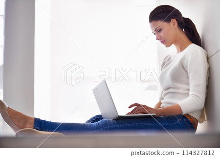 Laptop, typing and woman in home for remote work, social media or reading email on internet. Computer, freelancer and person on floor with technology for network, relax or blog on website in house 114327812