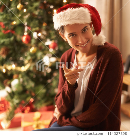 Portrait, woman and smile to point, you and christmas to show, choice, decision and invitation. Gen z female person, red hat or finger for pick, naughty or playful as humor to relax in festive season Portrait, woman and smile to point, you and christmas to show, choice, decision and invitation. Gen z female person, red hat or finger for pick, naughty or playful as humor to relax in festive season 114327898