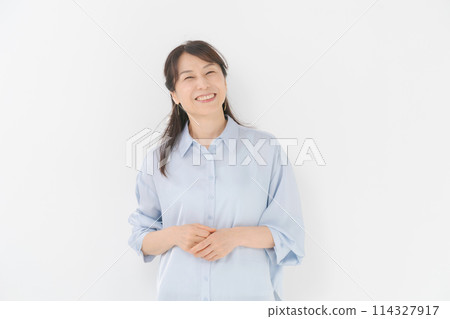 Middle-aged woman in a white shirt 114327917