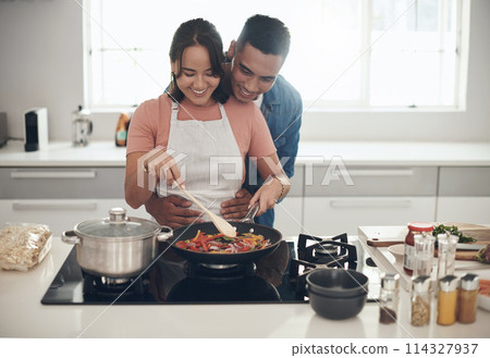 Hug, cooking and happy couple in kitchen together with healthy food, relationship and bonding in home. Diet, man and woman embrace in apartment with nutrition, care and meal prep for lunch with love 114327937