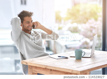 Business owner, phone call and desk for audio conversation, professional communication or telecom for online startup on laptop. Happy person, smile and cellular mobile in office for listen or discuss 114328027
