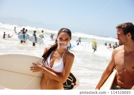 Couple, beach and surfboard for surfing or happiness with portrait, adventure and fitness with blue sky. Man, woman and surfer by ocean in the morning for holiday, vacation and freedom with swimwear 114328085